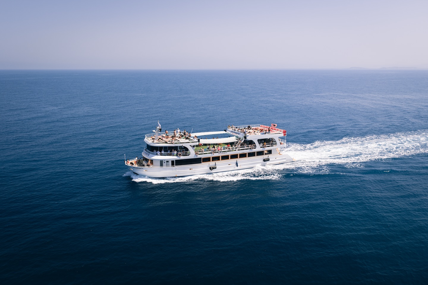 The Aquamarine Adventure 3-deck boat at sea
